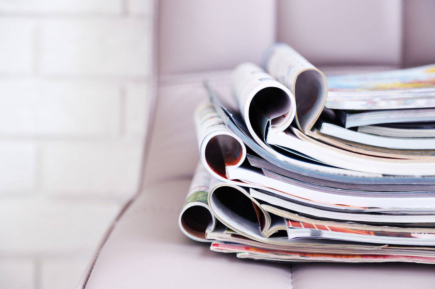 Stack of magazines on light lavender office chair, De Kay Events Featured in Bridal Guide