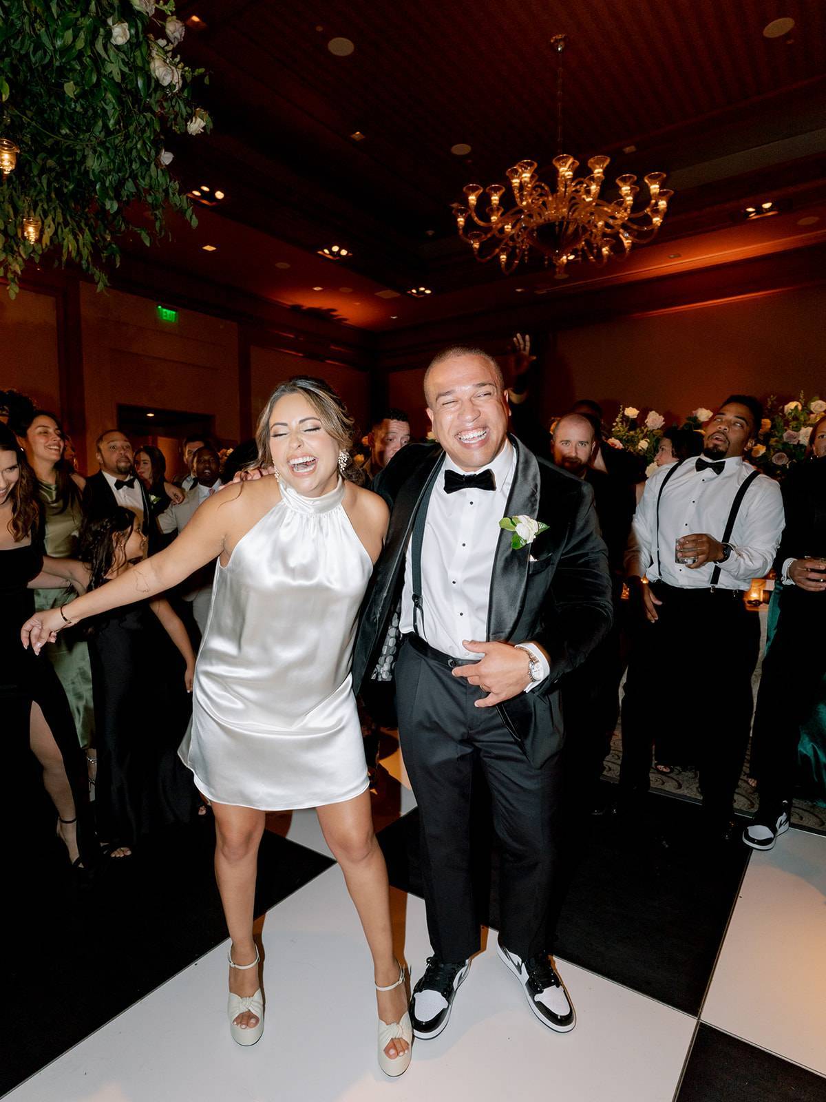 Happy newlyweds dancing on black and white dance floor, designed by Dee Kay Events.